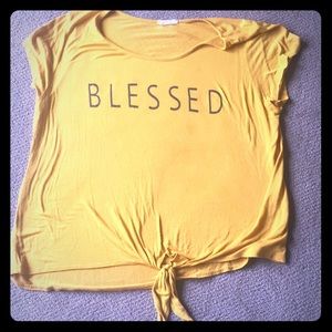 Yellow shirt with the word blessed on it
